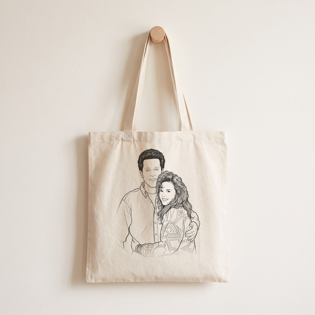 Line drawing of Kevin and Claire on a natural cotton tote, an example of SCG custom art made from a customer photo. Tote shown as a mockup.