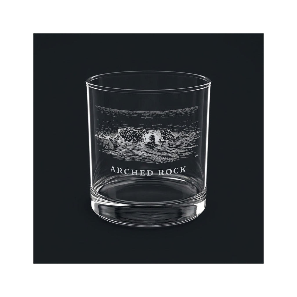 Engraved rocks glass with Arched Rock and the words ARCHED ROCK, shown on a dark background so the engraving stands out