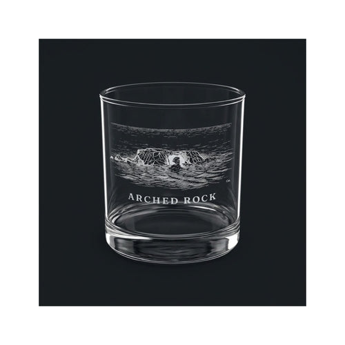 Engraved rocks glass with Arched Rock and the words ARCHED ROCK, shown on a dark background so the engraving stands out