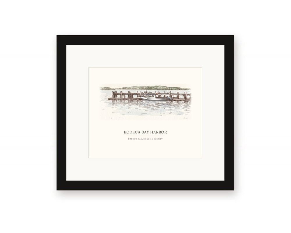 Framed watercolor print of the harbor at Bodega Bay, with a white mat in a black frame