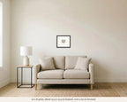 10 x 8 in framed watercolor of a black-tailed deer on Bodega Head hanging over a 60 inch loveseat, shown to scale