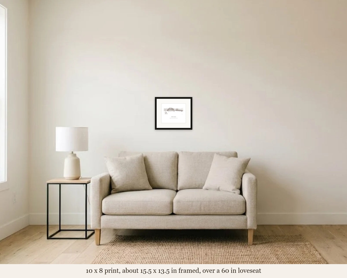 10 x 8 in framed Fort Ross ink drawing print hanging over a 60 inch loveseat, shown to scale