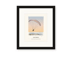Framed watercolor print of a paraglider over Goat Rock against a sunset sky, with a white mat in a black frame