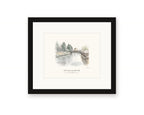 Framed watercolor print of the Petaluma River in downtown Petaluma, with a white mat in a black frame