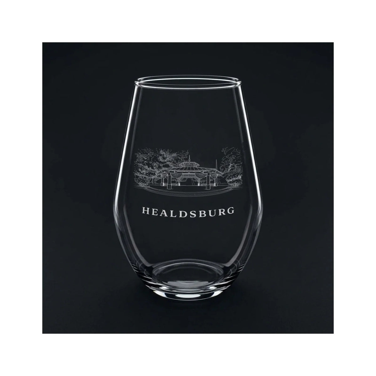Engraved stemless wine glass with the Healdsburg Plaza gazebo and the word HEALDSBURG, shown on a dark background so the engraving stands out