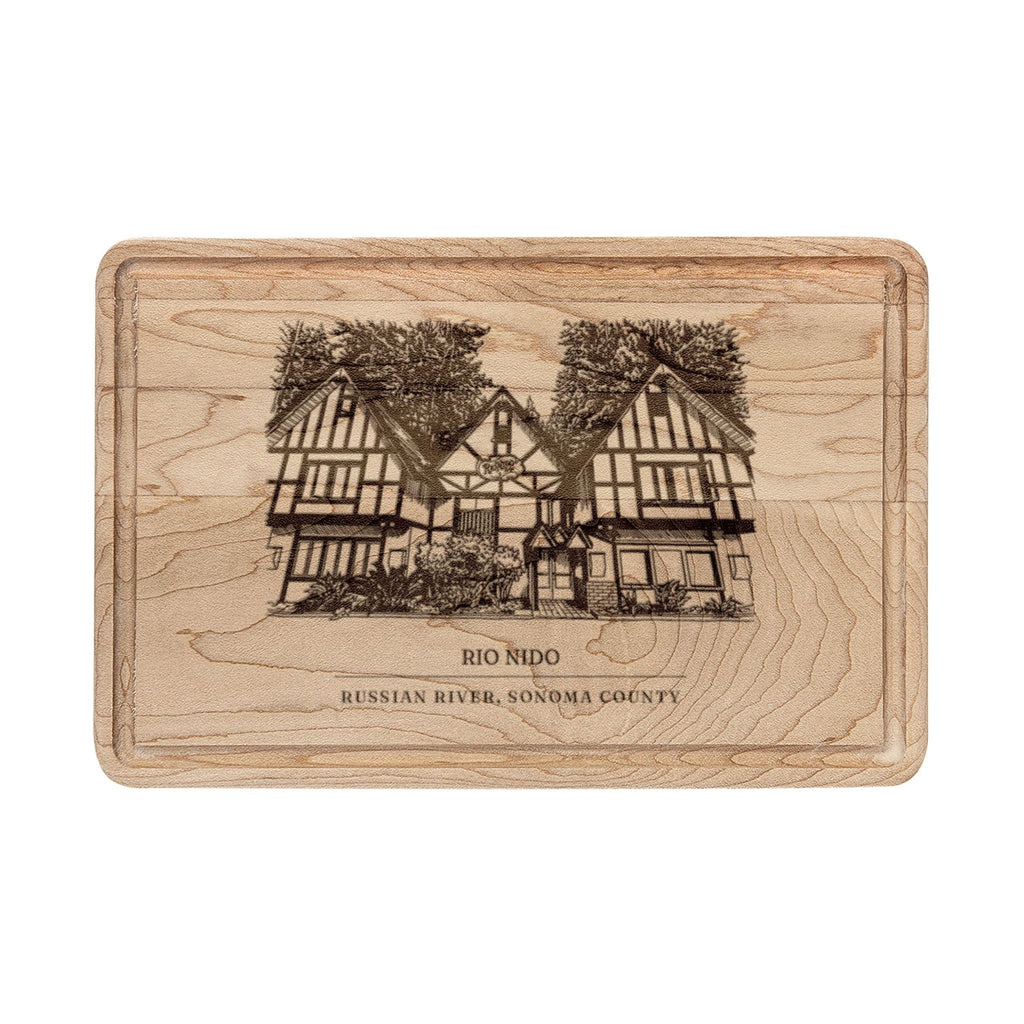 Maple cutting board engraved with a line drawing of the Tudor lodge in Rio Nido, Russian River